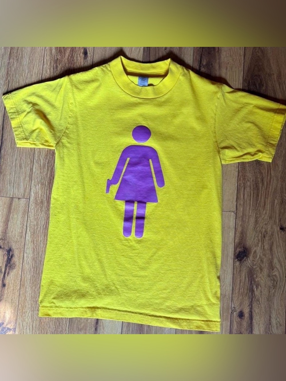 yellow graphic tee girl with gun